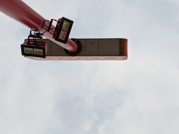 Low angle view of telephone booth against sky