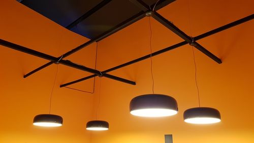 Low angle view of illuminated pendant lights