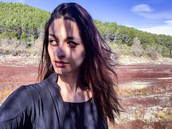 Portrait of beautiful young woman standing outdoors