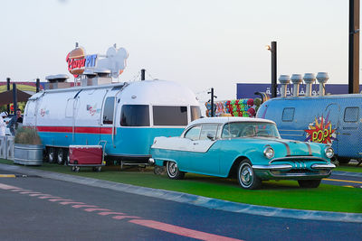 Cars on city street against clear sky