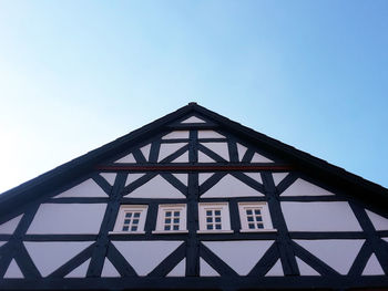 Low angle view of half-timbered house against clear sky