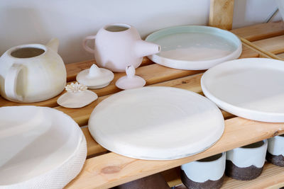 Pottery plates and bowls drying out waiting to be glazed