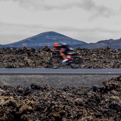 Person riding motorcycle on road