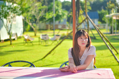 Young woman reading book at park