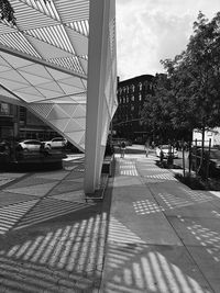 Cars on road in city against sky