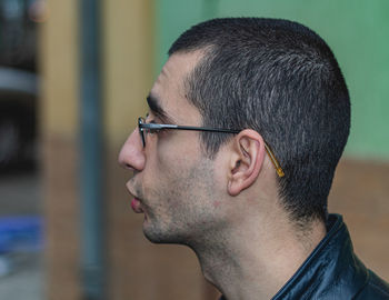 Close-up portrait of young man looking away