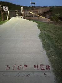 Rear view of people walking on riverbank