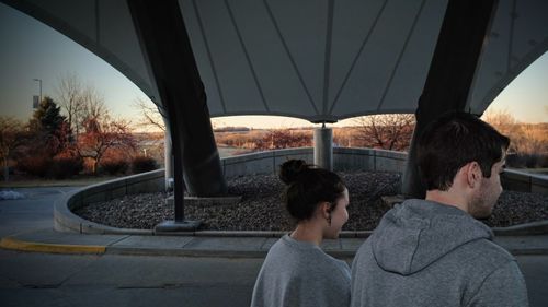 Couple walking on covered footpath during winter