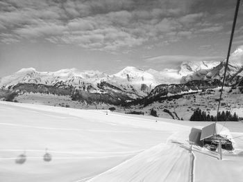 Scenic view of snow covered mountains against sky