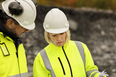 Engineers in reflective clothing looking at plans