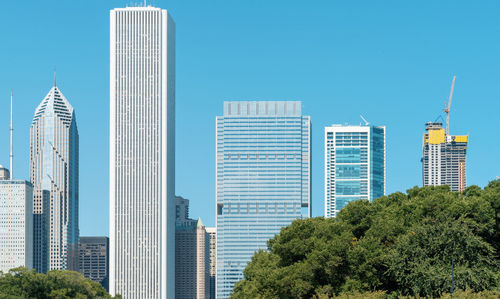 View of modern buildings against blue sky