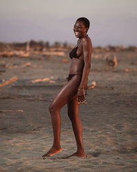 Full length portrait of woman standing on beach