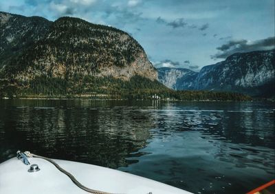 Scenic view of lake by mountains against sky