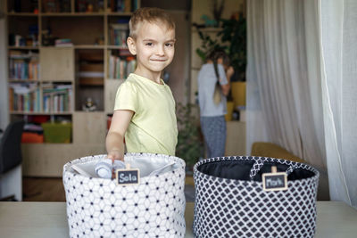 Portrait of cute girl standing in shelf