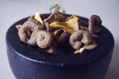 Close-up of edible mushrooms in bowl on table