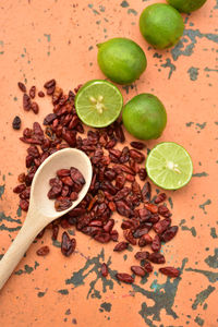 Cool green limes hot red dried chili peppers on tabletop