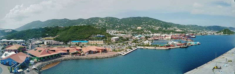 High angle view of townscape by sea against sky