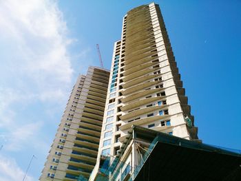 Low angle view of modern building against blue sky