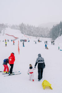 People skiing on snow covered landscape