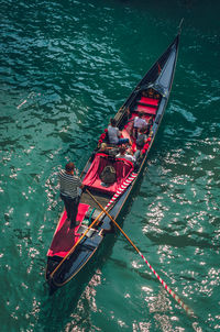 High angle view of people sitting on boat in canal