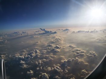 Aerial view of clouds over mountains against sky