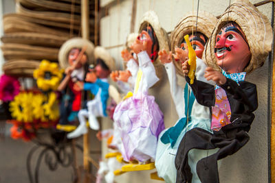 Close-up of puppets hanging for sale