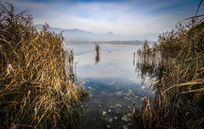 Scenic view of lake and mountains against sky