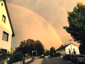 View of rainbow over city street