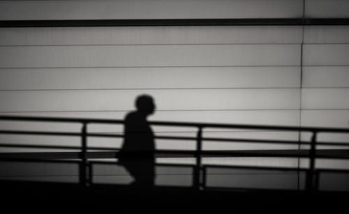 Side view of a shadow of man on wall