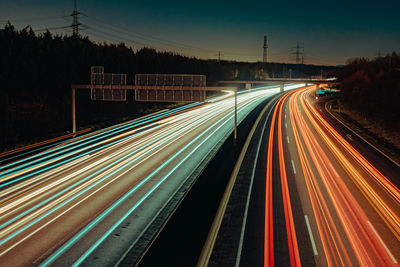 High angle view of light trails on highway at night