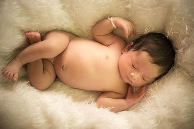 Cute baby boy sleeping on fur