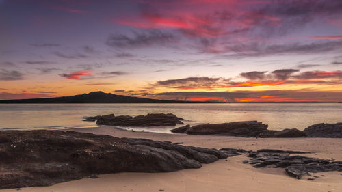 Scenic view of beach at sunset