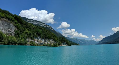 Scenic view of sea and mountains against sky