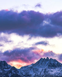 Scenic view of snowcapped mountains against sky during sunset