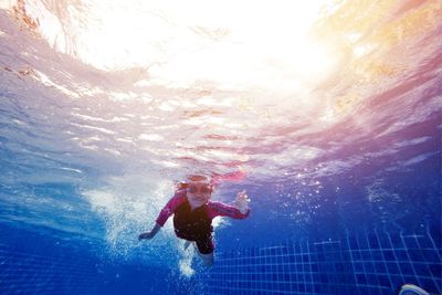 Low angle view of girl swimming in pool