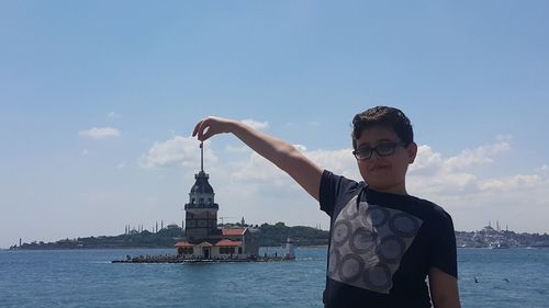 Full length of man standing on water against sky