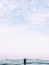 Man standing on beach against sky