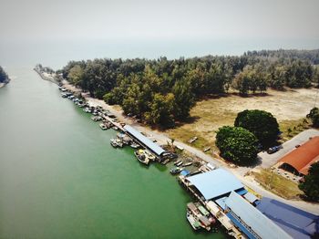 High angle view of swimming pool by river against sky