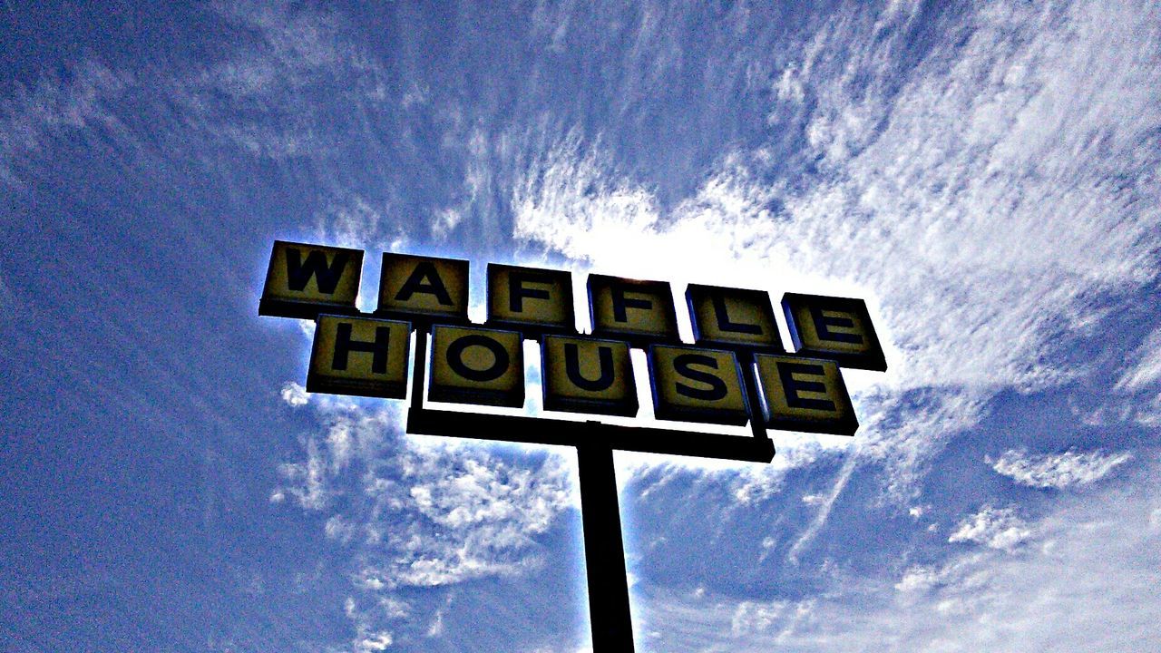 low angle view, sky, text, communication, western script, cloud - sky, blue, guidance, sign, cloud, road sign, information, information sign, capital letter, cloudy, no people, outdoors, day, nature, direction