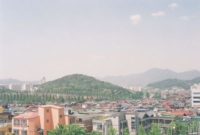 Cityscape with mountain range in background