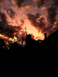 Low angle view of silhouette buildings against sky during sunset