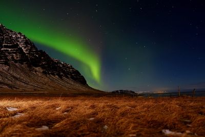 Low angle view of landscape against sky at night