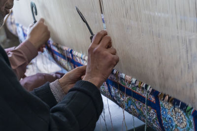 High angle view of man hand against graffiti