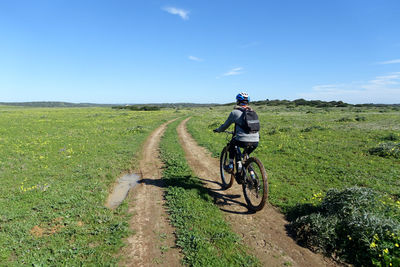 Teenager riding an electric mountain bike on a remote country track