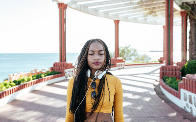 Portrait of young woman standing outdoors