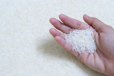 Close-up of hand on rug