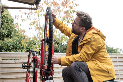 Rear view of man standing against white background