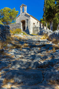 Low angle view of historic building against blue sky