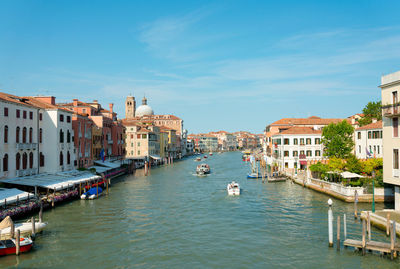 Boats in canal passing through city