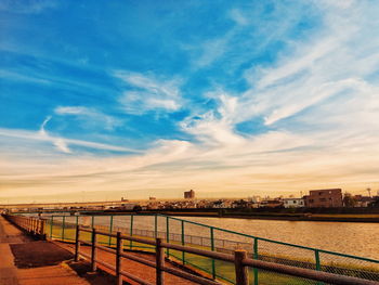 Bridge over river against sky in city